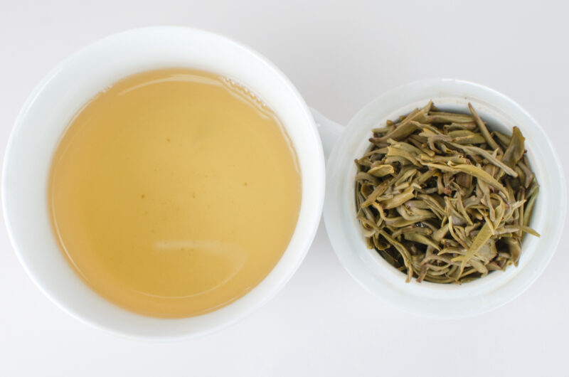 Cupped infusion of Zhi Xiang Ganlu (Gardenia Sweet Dew) scented green tea and strained leaves.
