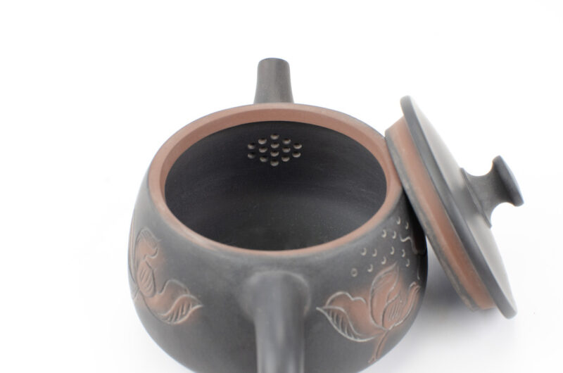 Inset strainer behind spout inside Fish and Lotus Carved Yunnan Black Jianshui Teapot