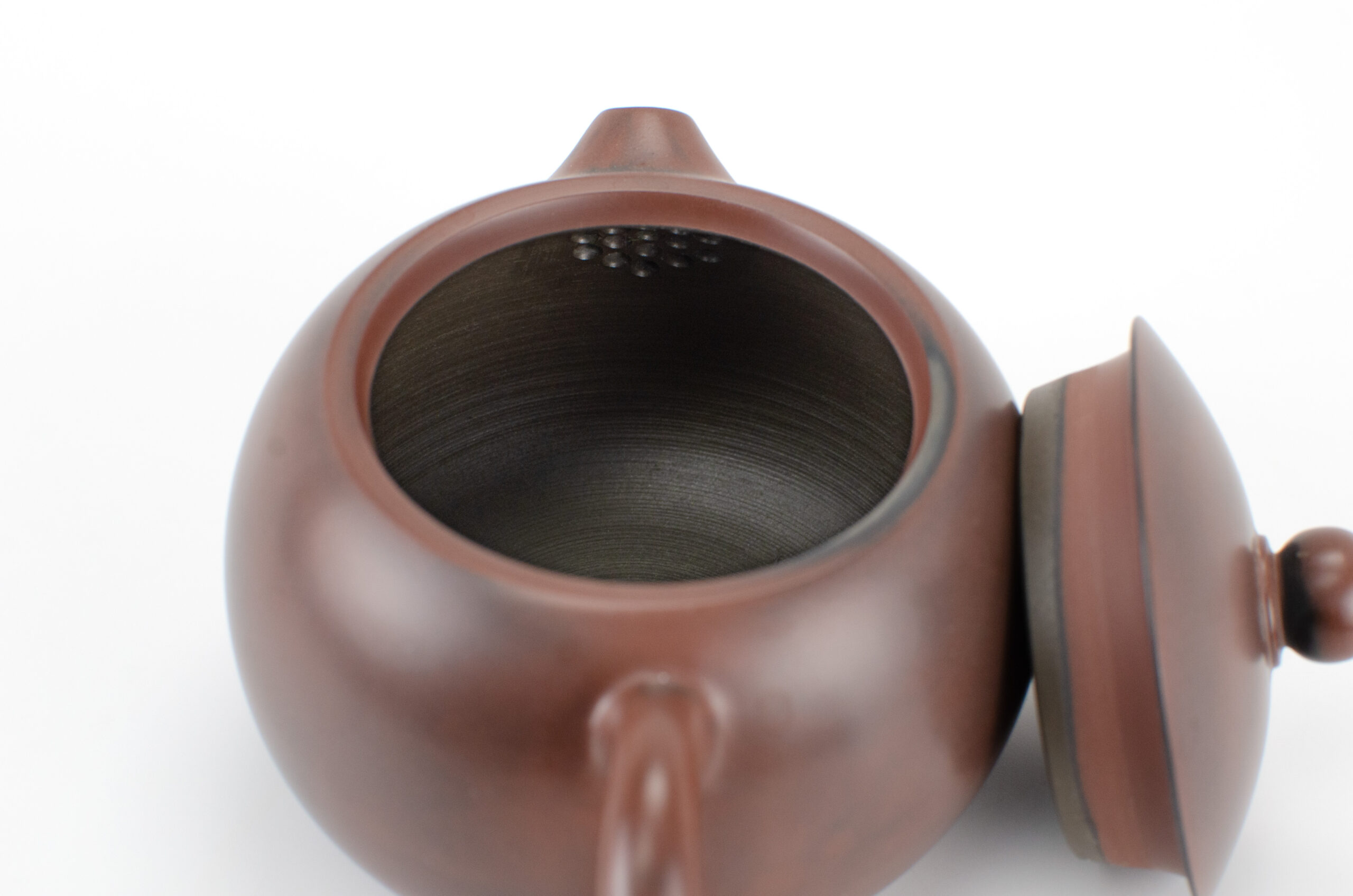 Inset strainer behind spout inside Xishi Shape Guangxi Nixing Clay Teapot