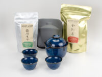 The two teas and travel tea set included in The Essentials Kit, with one easy gaiwan, three cups, and their carrying case.