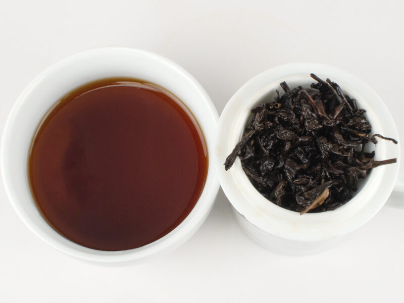 Aged Jingmai Shu puer tea and strained leaves.