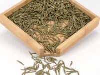 Mengding Huangya (Handmade Yellow Buds) yellow tea dry leaves in a wooden display box.