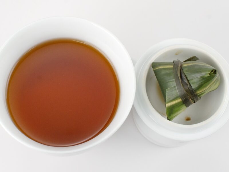 Qimen Zongzi (Bamboo Keemun) black tea and strained leaves.