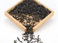 Tongmu Rougui (Tongmu Cassia Bark) rock wulong tea dry leaves in a wooden display box.