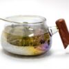 Goldfish Rainbow Glass Pitcher with Wood Handle filled with tea