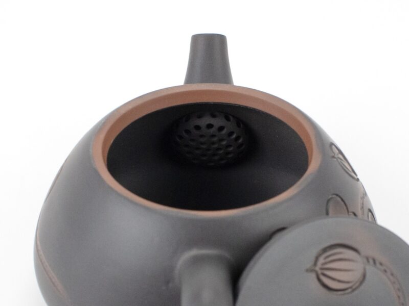 Strainer inside spout of Lotus Carved Stone Scoop Yunnan Black Jianshui Teapot