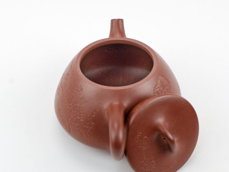 Strainer inside Plum Blossom Stone Scoop Da Hong Pao Yixing Teapot