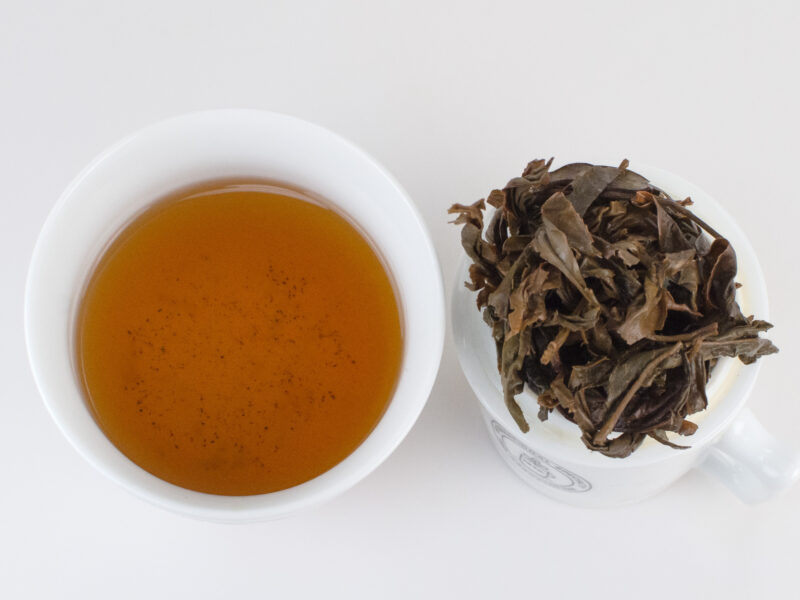 Jingmai Huangpian 2007 sheng puer tea infusion and steeped leaves.