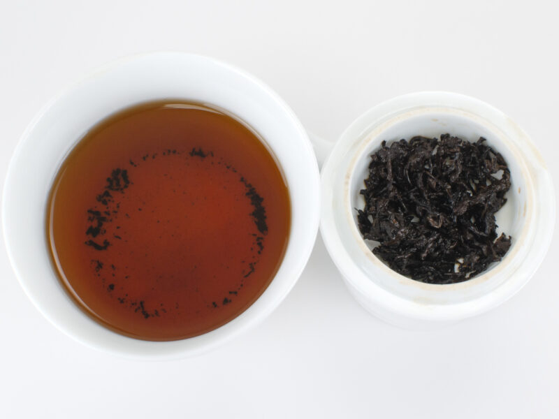 Cupped infusion of 520 Brick 2008 shu puer tea and strained leaves.