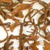 Yiwu Sun-Dried Yunnan black tea leaves in clear water.