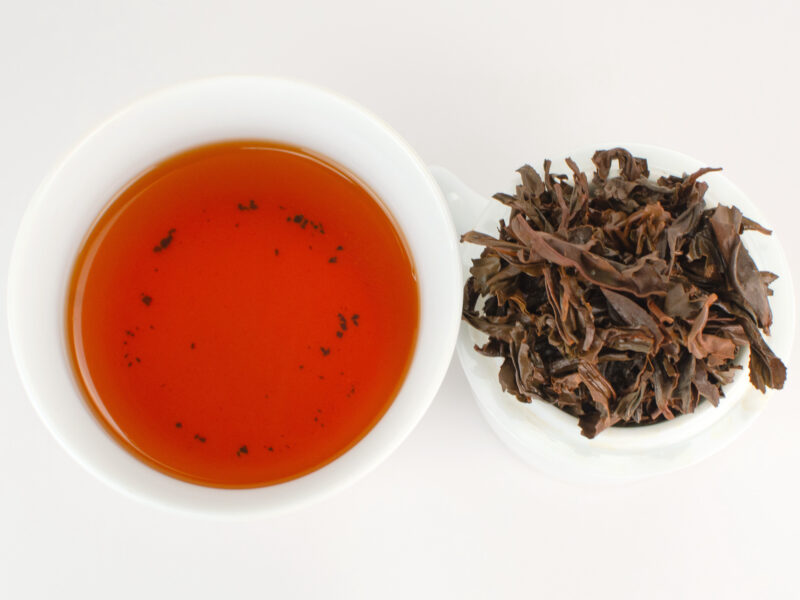 Cupped infusion of Zui Tao Xi (The Drunkest Peach) Tongmu black tea and strained leaves.