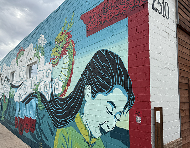 A colorful mural on a brick wall.