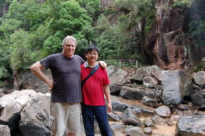 two men standing by a stream in jinggu province