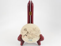 Youle Huangshancha (Youle Forest Tea) sheng puer cake in paper wrapper.