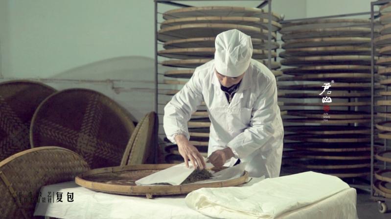 The first wrapping during the menhuang process. The tea leaves are still hot from wok frying.
